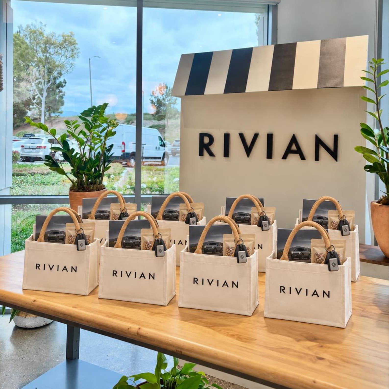 Branded canvas tote bags arranged for a corporate gifting event